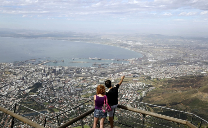 Visitors enjoy the view over the city of Cape Town from the top of Table Mountain, one of South Africa's biggest tourist attractions above Cape Town.