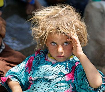 A Yazidi girl, fleeing the violence in the Iraqi town of Sinjar, at the Iraqi-Syrian border crossing.