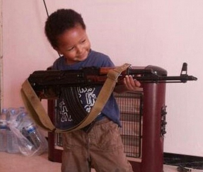 Dare's Twitter profile shows her toddler son posing with an AK47 rifle.