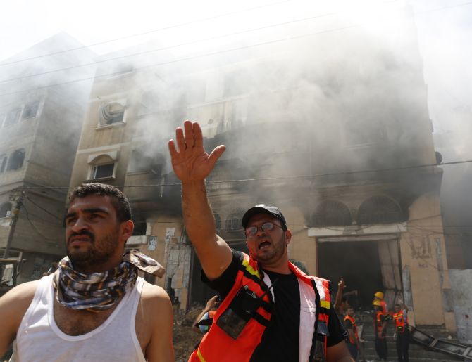 A Palestinian firefighter reacts at the scene of what witnesses said was an Israeli air strike on a house in Gaza City.