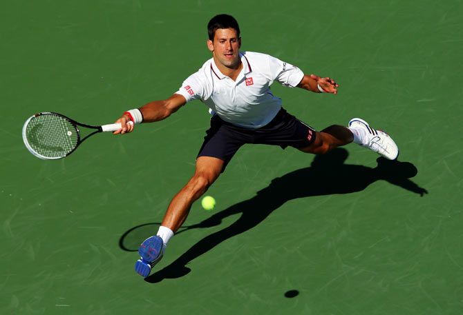 Novak Djokovic of Serbia returns a shot against Paul-Henri Mathieu of France during their US Open men's second round match on Thursday