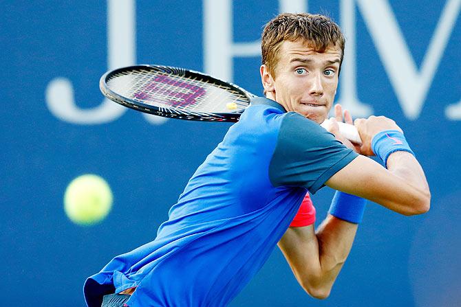 Andrey Kuznetsov of Russia returns a shot against Fernando Verdasco of Spain on Thursday