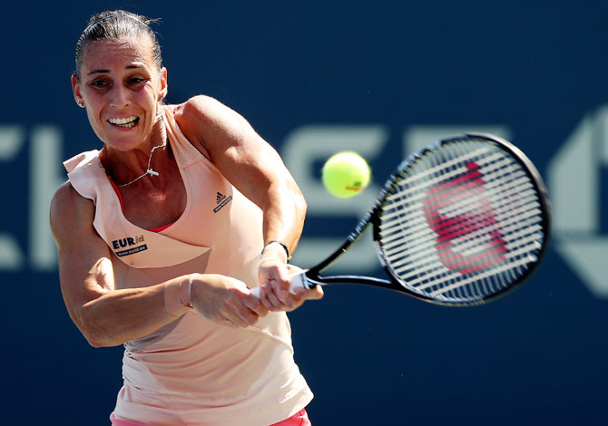 Flavia Pennetta of Italy returns a shot to Shelby Rogers of the United States on Thursday