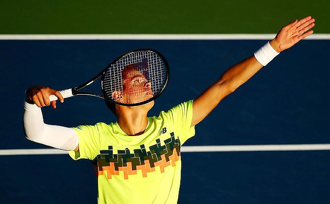 Milos Raonic of Canada serves against Peter Gojowczyk of Germany on