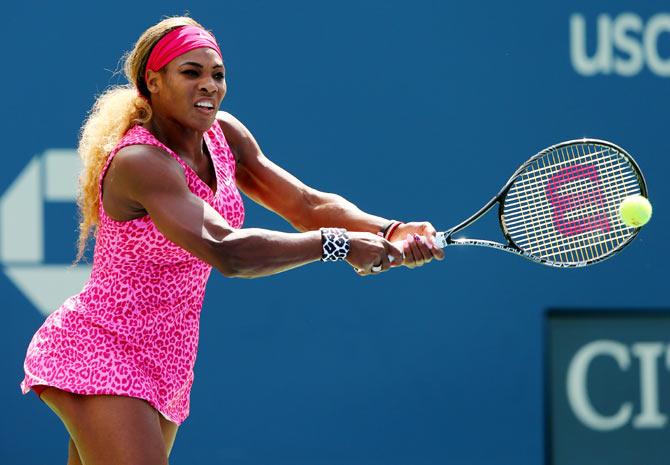 Serena Williams of the United States returns a shot against Vania King of the United States during their US Open women's singles second round match on Thursday