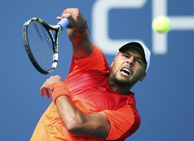 Jo-Wilfried Tsonga of France hits a smash against Aleksandr Nedovyesov of Kazakhstan during their US Open match on Thursday