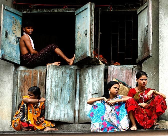 Sex workers sit outside their cramped quarters in Mumbai's red light district.