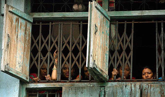 Sex workers wait for clients in a red light area in Mumbai.