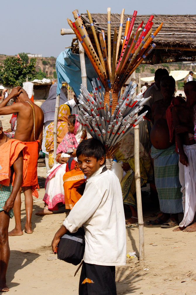 A flute seller boy on the Banks of the Sangam