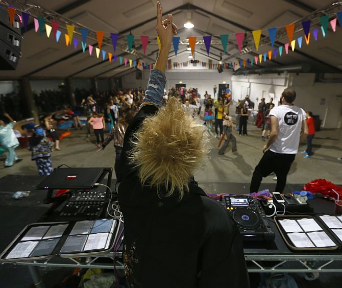 A DJ plays dance music to revellers at Morning Glory, in a venue in Hackney, London