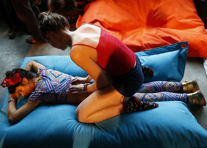 A reveller enjoys a massage at Morning Glory, in a venue in Hackney, London