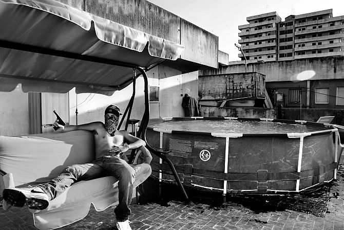 Naples, Scampia neighborhood, a large area under Camorra control, the biggest area in Europe known for drug selling. A pusher with his gun on the roof of a building called The Sails