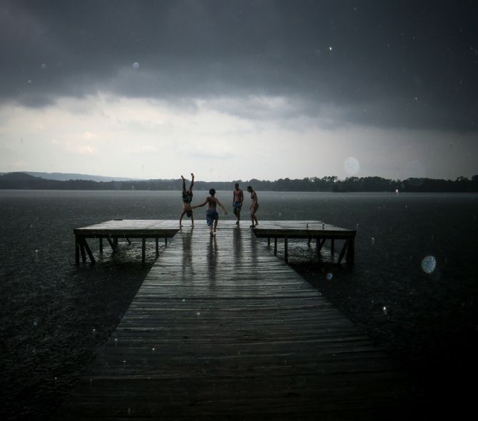 In your youth, nothing can stop you from enjoying time with your friends, especially not a simple matter of rain during summer fun. You may grow up and forget the names, but you'll always remember the moments, the time on the dock with your friends during a surprise shower.