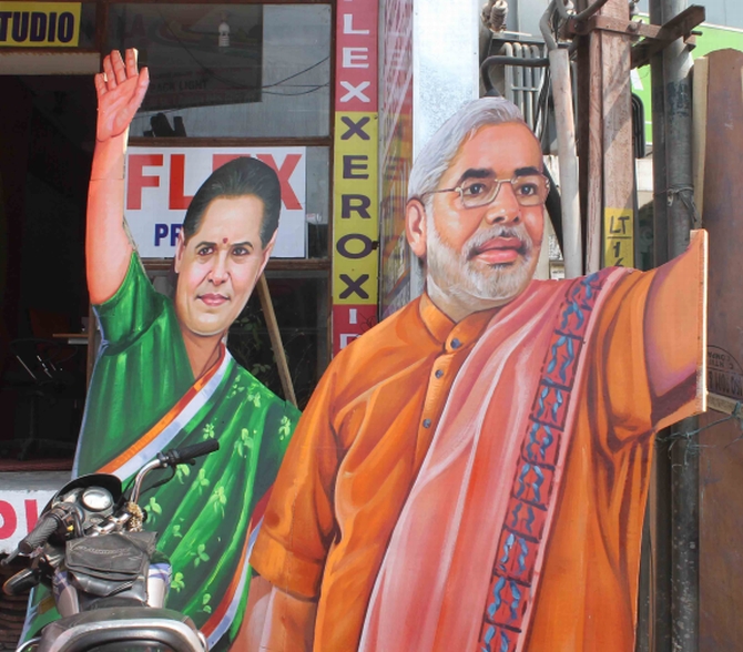 Cut-outs of Congress President Sonia Gandhi and Gujarat Chief Minister Narendra Modi