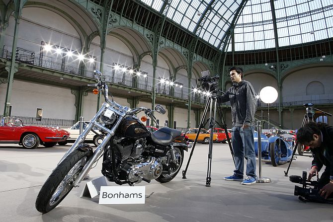 Cameramen shoot the 1,585 cc Harley Davidson Dyna Super Glide