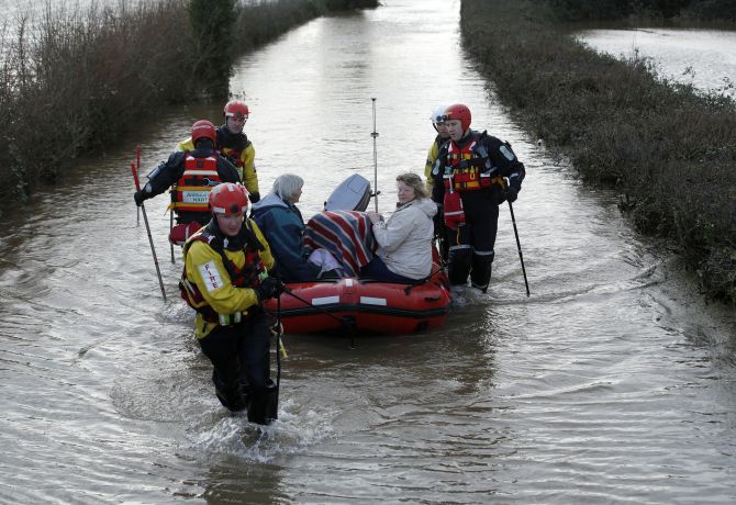 Residents are rescued by the Devon and Somerset Fire and Rescue service during continued flooding at Burrowbridge in south west England.