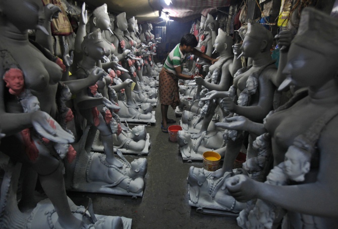 An artist paints an idol of Kali at a workshop in Kolkata.