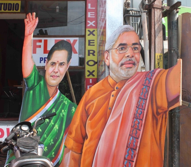 Cut-outs of Congress President Sonia Gandhi and BJP's PM candidate Narendra Modi at a political rally