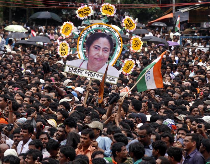 Supporters hold a cut-out of Bengal CM Mamata Banerjee