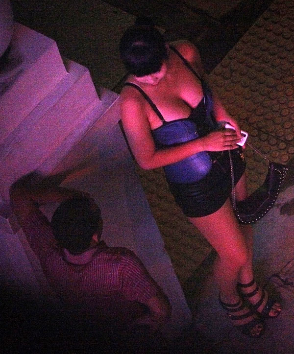 A suspected prostitute is seen speaking with a man at Dongguan, in China's Guangdong province
