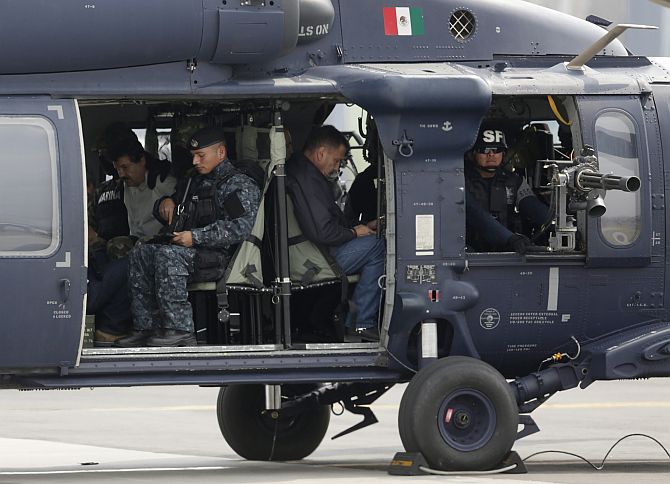 Joaquin Shorty Guzman is seen sitting inside a Mexican federal police helicopter at the Navy's airstrip in Mexico City 