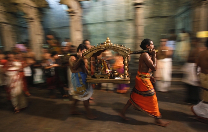 Priests carry a shrine of Lord Shiva to bless devotees as they pray during the annual Maha Shivaratri festival at Shivam Kovil in Colombo.