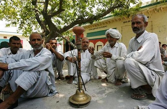 Villagers sit after attending a panchayat, or village council meeting, at Balla village in Haryana