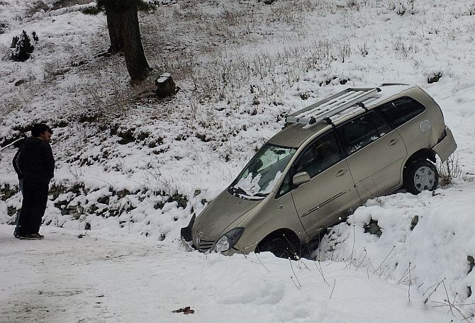 A vehicle slips off the road post snowfall in Srinagar
