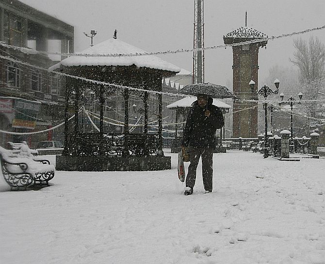 A Kashmiri braves the snowfall in Srinagar