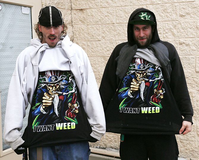 Mark Gordon (left) and Ryan Perry display their I Want Weed t-shirts as they wait in line to be among the first to legally buy recreational marijuana at the Botana Care store in Northglenn, Colorado