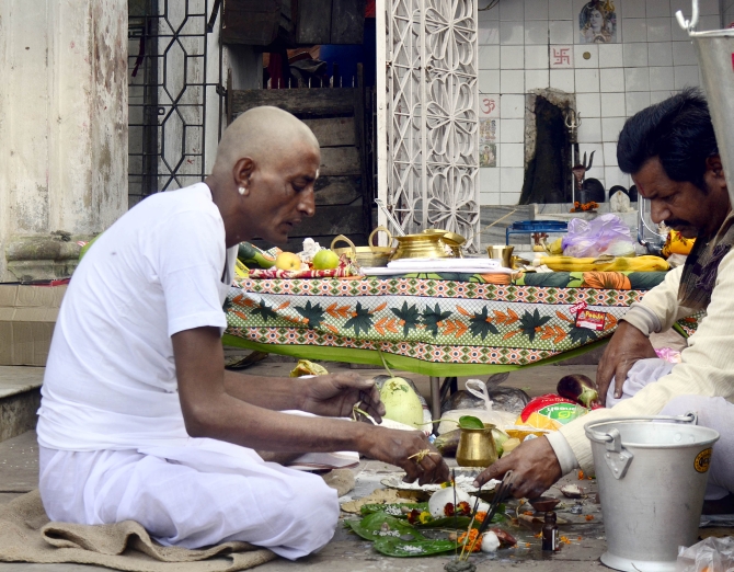 Jha performs rituals for his daughter at Nimtala in Kolkata