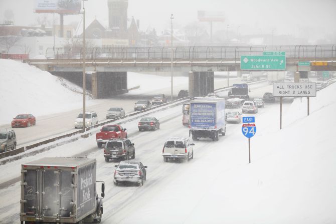Motorists drive along a snow covered Interstate-94 in Detroit, Michigan on Friday