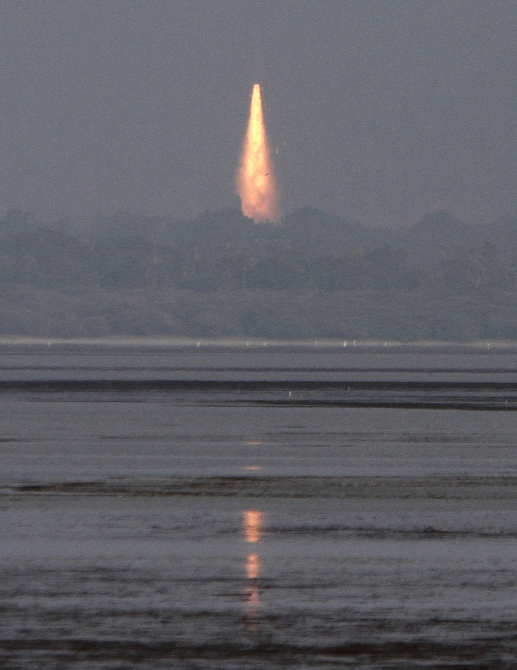 A contrail is seen as India's Geosynchronous Satellite Launch Vehicle blasts off carrying a 1,980 kg GSAT-14 communication satellite from the Satish Dhawan space centre at 