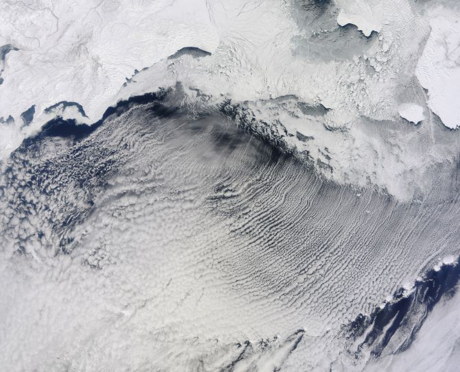 Clouds stretch in parallel rows for hundreds of kilometers over the Bering Sea in this NASA handout photo