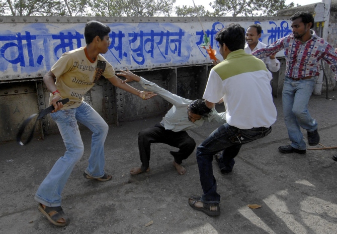 MNS party workers attack a man while targeting people leaving a Samajwadi Party rally in Mumbai in this photograph taken on February 3, 2008.