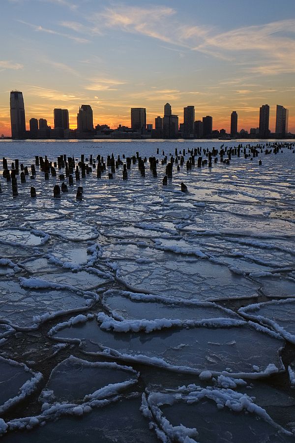 Ice floes fill the Hudson River as the New Jersey waterfront is seen during sunset on January 9, 2014 in New York City