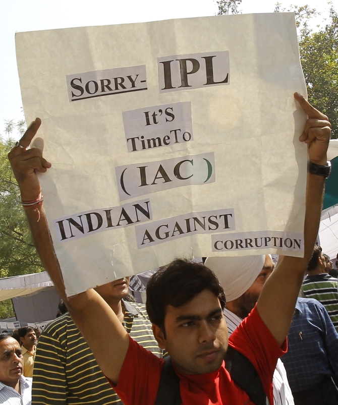 A protester holds a sign during a campaign against corruption in New Delhi