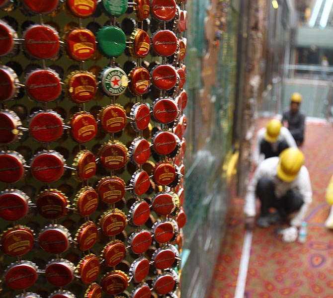 The artwork made of bottle caps. Beyond that is the Mumbai Google Map, made of recycled materials.