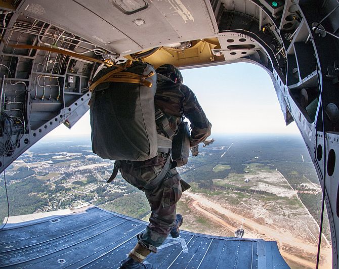 An Indian army paratrooper with the 50th Independent Parachute Brigade, exits a helicopter during a partnered airborne training exercise.