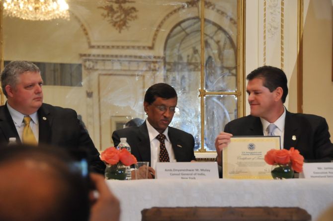 Shawn Bray, director, Interpol, Washington, left, looks on as Ambassador Dnyaneshwar M Mulay, India's consul general in New York, centre, accepts the certificate of transfer from James Dinkins, executive associate director of the Immigration and Customs Enforcement's Homeland Security Investigations.