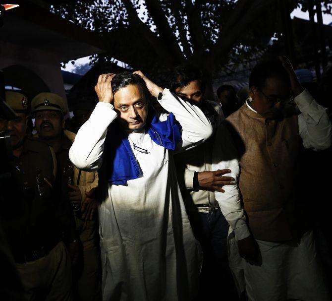 Union Minister Shashi Tharoor gestures after performing the last rites for his wife Sunanda Puskhar at a cremation ground in New Delhi on Saturday.