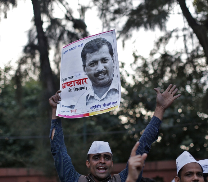 A supporter of the Aam Aadmi Party holds a portrait of Delhi's chief minister Arvind Kejriwal during a protest in New Delhi