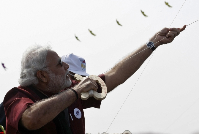 Narendra Modi, prime ministerial candidate for India's main opposition Bharatiya Janata Party and Gujarat's chief minister, flies a kite at the international kite festival in Ahmedabad.