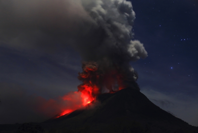 Mount Sinabung is seen during an eruption from Naman Teran village in Karo district, Indonesia's North Sumatra province. The authorities raised the alert status for the volcano to the highest level in November 2013.