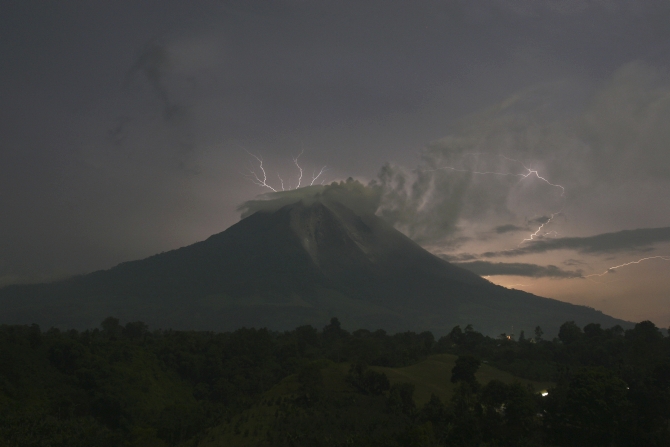 Lightning strikes as Mount Sinabung volcano spews ash and hot lava, at Simpang Empat village in Karo district, Indonesia's North Sumatra province.