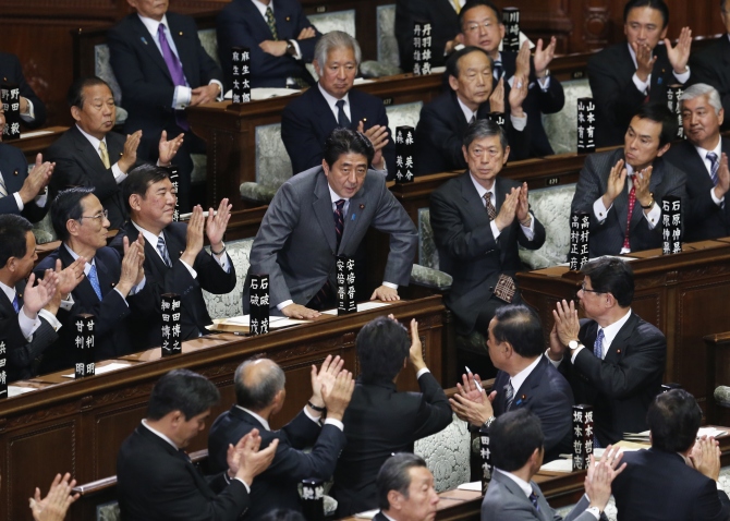 Shinzo Abe is applauded by his party members after being elected as Japan's prime minister at the lower house of the parliament in Tokyo in this photograph taken on December 26, 2012.