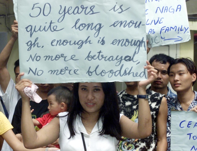 An activist of Naga Student Association holds a poster during a demonstration in Calcutta.