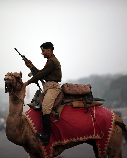A Border Security Force soldier rides his camel during a rehearsal for the 'Beating the Retreat' ceremony'