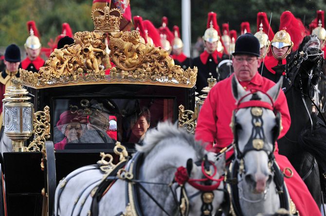Queen Elizabeth II arrives at Buckingham Palace in her royal carriage