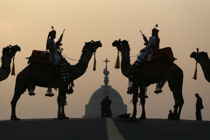 Border Security Force soldiers ride their camels in front of India's presidential palace Rashtrapati Bhavan during a rehearsal for the 'Beating the Retreat' ceremony in New Delhi